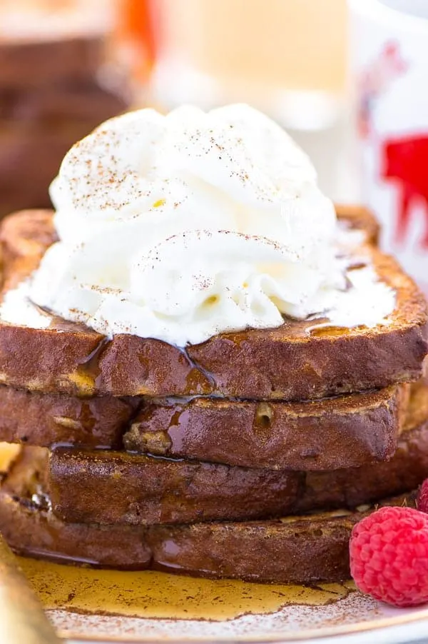 This Gluten Free Eggnog French Toast is the perfect breakfast during the holiday season. You can make it ahead too and reheat it for your holiday brunch! For dairy free, use non-dairy eggnog. Recipe from @whattheforkblog | whattheforkfoodblog.com | recipes for Christmas brunch | gluten free breakfast recipes | easy French toast recipes | #Christmas #frenchtoast #breakfast #glutenfree #easyrecipes #recipe #eggnog #brunch