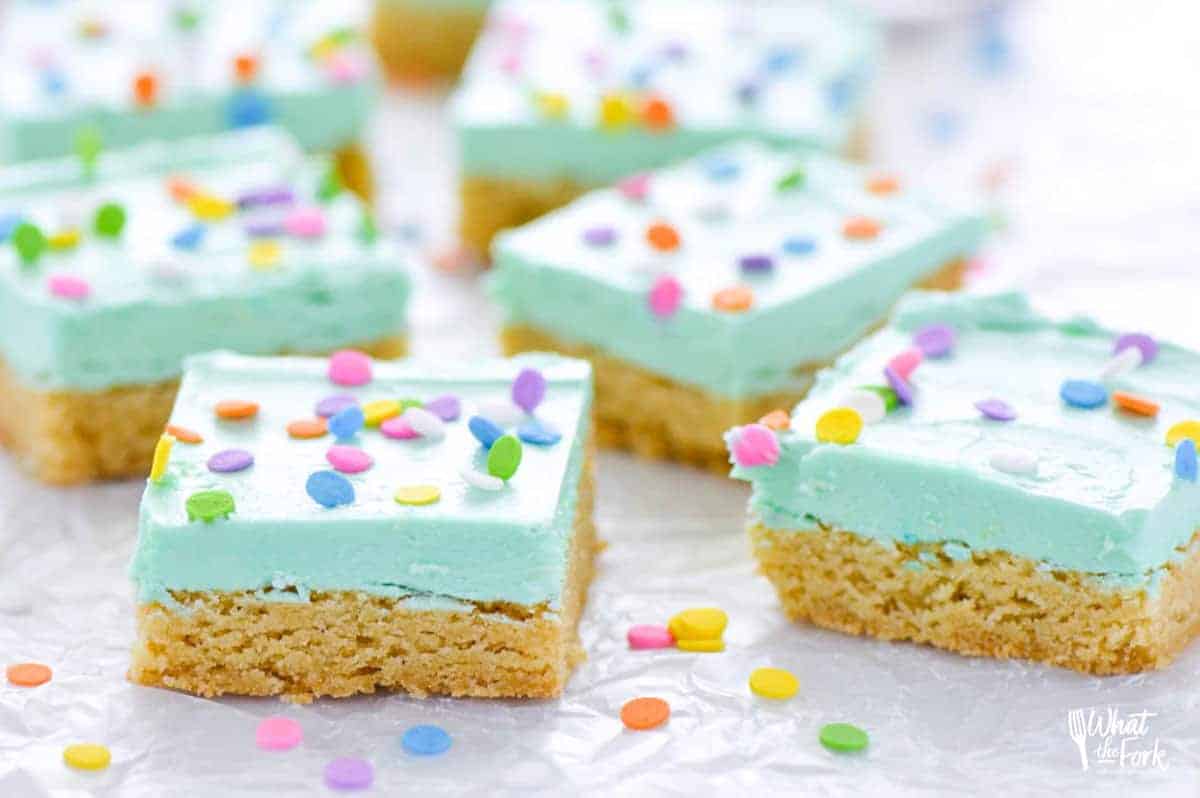 Soft gluten free sugar cookie bars that will bring smiles to the faces of all who eat them! Easier to make than cut out sugar cookies with the same flavor you love. Don’t forget the sprinkles! Recipe from @whattheforkblog | whattheforkfoodblog.com | gluten free dessert recipes | gluten free desserts | easy gluten free sugar cookies | bar cookie recipes | easy gluten free recipes | vanilla buttercream frosting recipe | #glutenfree #easyrecipes #glutenfreedessert #dessert #sugarcookies #barcookies #glutenfreecookies