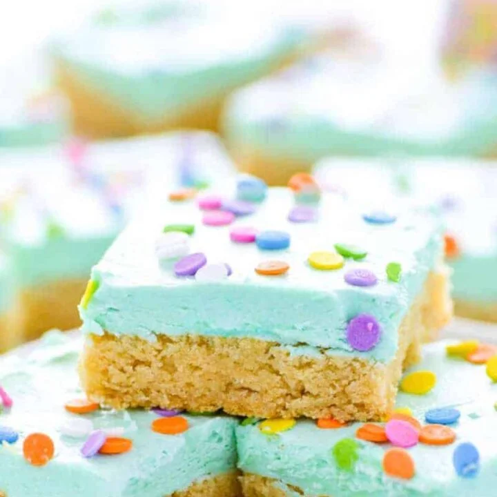 Soft gluten free sugar cookie bars that will bring smiles to the faces of all who eat them! Easier to make than cut out sugar cookies with the same flavor you love. Don’t forget the sprinkles! Recipe from @whattheforkblog | whattheforkfoodblog.com | gluten free dessert recipes | gluten free desserts | easy gluten free sugar cookies | bar cookie recipes | easy gluten free recipes | vanilla buttercream frosting recipe | #glutenfree #easyrecipes #glutenfreedessert #dessert #sugarcookies #barcookies #glutenfreecookies
