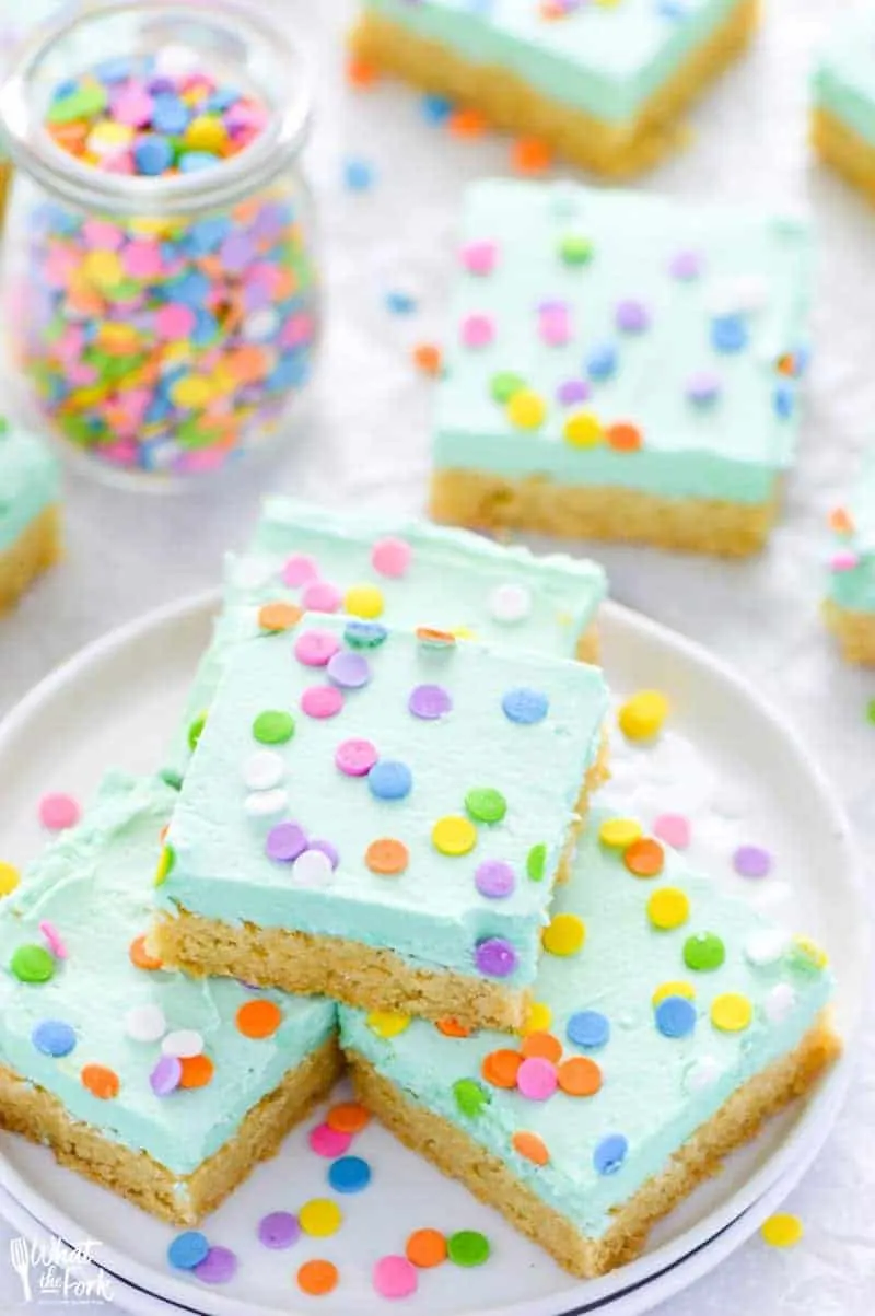 Soft gluten free sugar cookie bars that will bring smiles to the faces of all who eat them! Easier to make than cut out sugar cookies with the same flavor you love. Don’t forget the sprinkles! Recipe from @whattheforkblog | whattheforkfoodblog.com | gluten free dessert recipes | gluten free desserts | easy gluten free sugar cookies | bar cookie recipes | easy gluten free recipes | vanilla buttercream frosting recipe | #glutenfree #easyrecipes #glutenfreedessert #dessert #sugarcookies #barcookies #glutenfreecookies