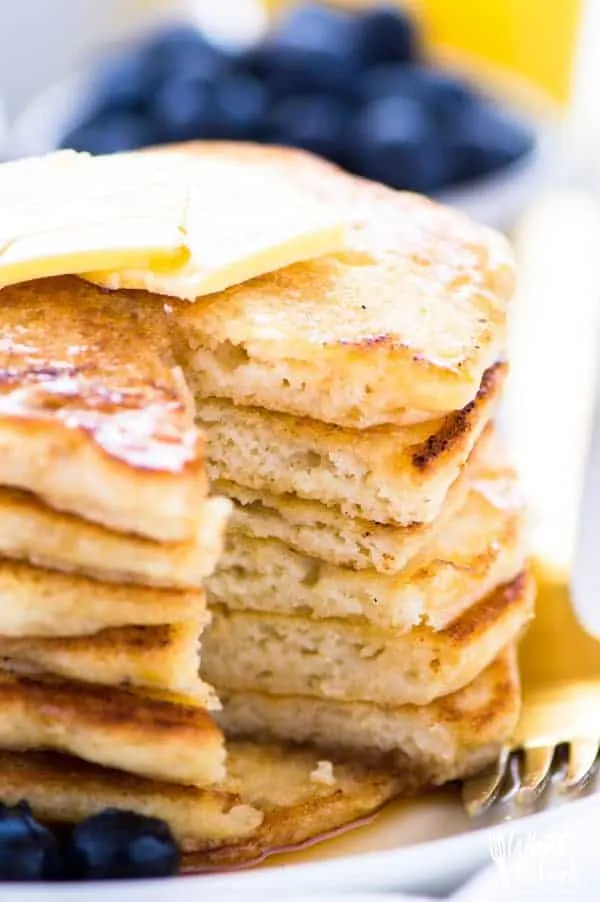 Side shot of gluten free pancakes that are fluffy and thick.