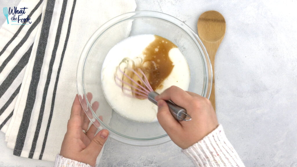 In a large bowl, whisk together the eggs, milk, oil, maple syrup, and vanilla extract.