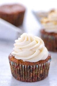 gluten free carrot cake cupcake with cream cheese frosting on platter