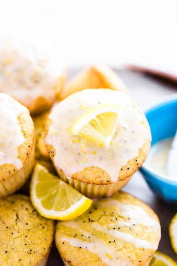 close up of gluten free lemon poppy seed muffin with a slice of lemon for garnish
