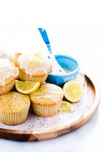 gluten free lemon poppy seed muffins on a brown wood platter