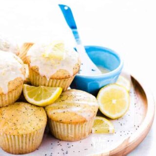 gluten free lemon poppy seed muffins on a brown wood platter