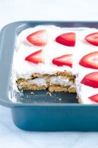 Gluten Free Strawberry Icebox Cake in a metal pan with a slice cut out