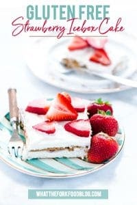 gluten free strawberry icebox cake slice on a plate with a small fork and strawberries