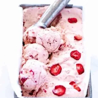 No-churn strawberry ice cream recipe being scooped with a silver ice cream scoop