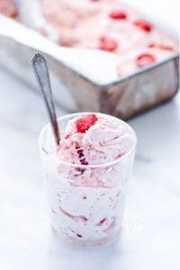 No-Churn strawberry ice cream recipe scooped into a cup with a spoon