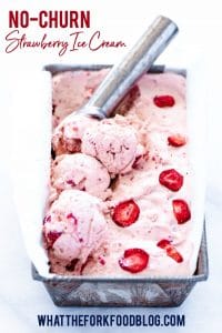 Finished no churn strawberry ice cream recipe being scooped with a silver ice cream scoop