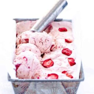 No-churn strawberry ice cream recipe being scooped with a silver ice cream scoop