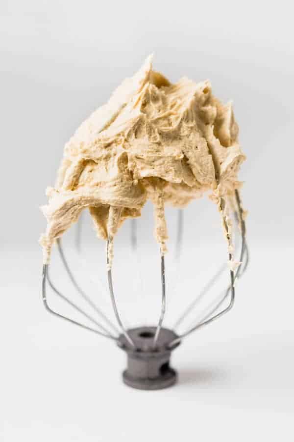 Whipped Peanut Butter Frosting on a wire whisk