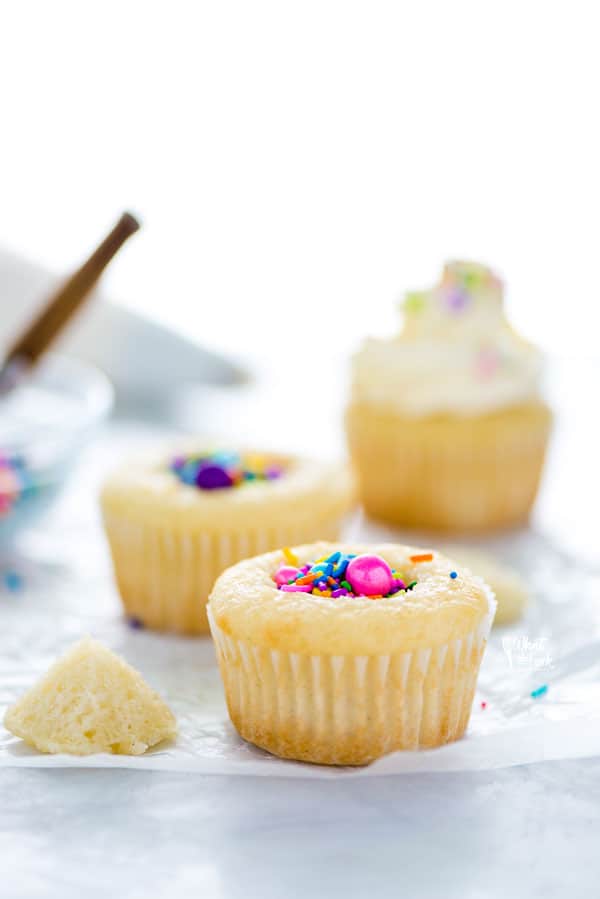Elevate your standard cupcake and learn how to make Piñata Cupcakes! They’re easy to make and super fun to eat! Two versions included - chocolate piñata cupcakes and vanilla piñata cupcakes. These are perfect for birthdays, birthday parties, gender reveal cakes and baby showers! Customize the sprinkles for any holiday too. Easy dessert recipe from @whattheforkblog - visit whattheforkfoodblog.com for more #cupcakes #baking #dessert #diy #tutorial #easyrecipe #glutenfree #cakedecorating #sprinkles