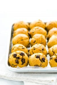 Gluten Free Pumpkin Chocolate Chip Cookies lined up on a metal sheet pan lined with wax paper