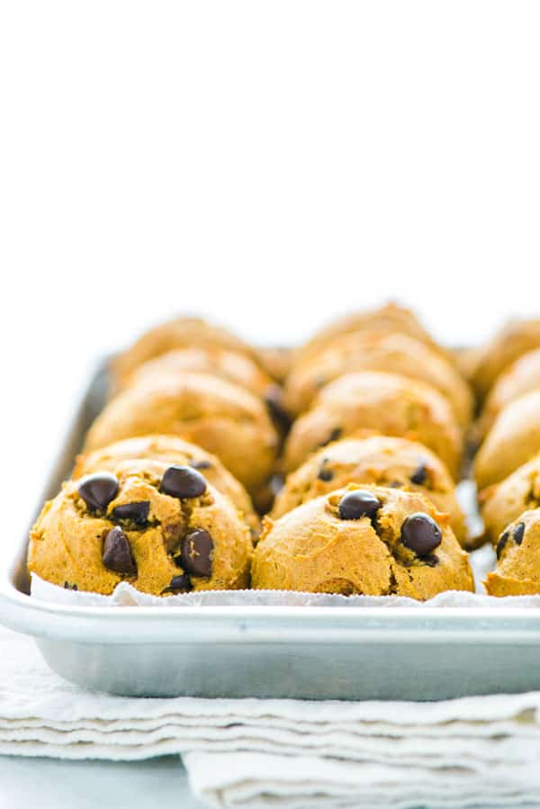 Gluten Free Pumpkin Chocolate Chip Pumpkin Cookies lined on a metal sheet pan