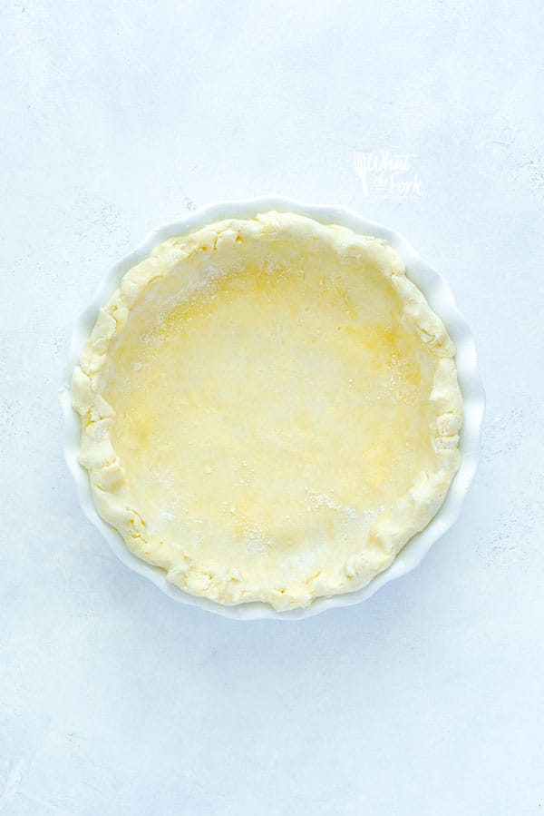 Unbaked Gluten Free Pie Crust in a white pie dish