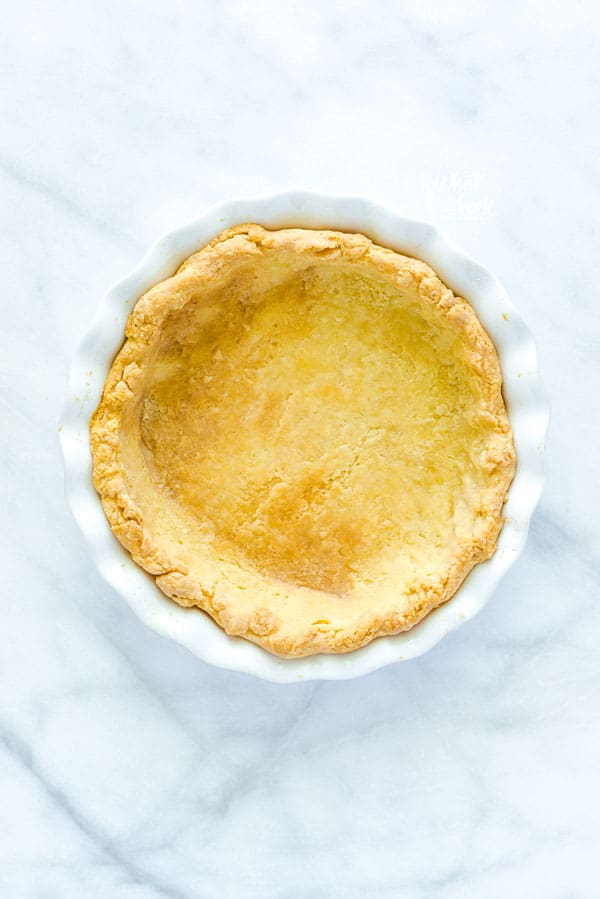 blind bake pie crust in a white pie plate