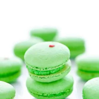 A short stack of green Grinch Heart French Macarons