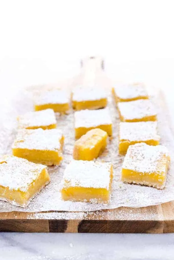 This is the best recipe for gluten free Meyer Lemon Bars! They're simple and easy to make and are tangy, citrusy, and gooey with an incredible shortbread crust! They’re perfect for Easter, baby showers, bridal showers, or any celebration. This easy recipe for lemon bars is one you have to try - they’re simply irresistible! Helpful post/guide includes lots of tips! Gluten Free Desserts recipe from @whattheforkblog - visit whattheforkfoodblog.com for more! #glutenfree #lemon #MeyerLemon #desserts