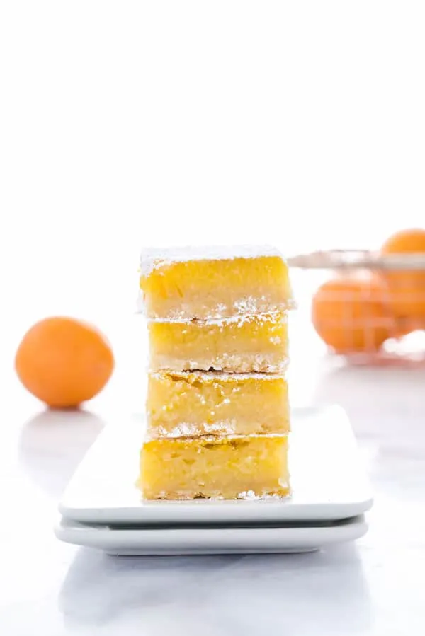This is the best recipe for gluten free Meyer Lemon Bars! They're simple and easy to make and are tangy, citrusy, and gooey with an incredible shortbread crust! They’re perfect for Easter, baby showers, bridal showers, or any celebration. This easy recipe for lemon bars is one you have to try - they’re simply irresistible! Helpful post/guide includes lots of tips! Gluten Free Desserts recipe from @whattheforkblog - visit whattheforkfoodblog.com for more! #glutenfree #lemon #MeyerLemon #desserts