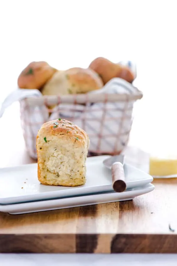 Soft, yeasty gluten free rolls made with garlic and herbs! These rolls are easy to make and have an amazing texture you wouldn’t believe until you try it! These gluten free dinner rolls truly are a revolutionary gluten free bread product. Serve them with holiday meals, Sunday dinner, or even with weeknight dinners. Gluten free bread recipe from @whattheforkblog - visit whattheforkfoodblog.com for more #glutenfree #glutenfreebread #glutenfreebaking #bread #yeastrolls #glutenfreerecipes #rolls