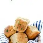 Soft, yeasty gluten free rolls made with garlic and herbs! These rolls are easy to make and have an amazing texture you wouldn’t believe until you try it! These gluten free dinner rolls truly are a revolutionary gluten free bread product. Serve them with holiday meals, Sunday dinner, or even with weeknight dinners. Gluten free bread recipe from @whattheforkblog - visit whattheforkfoodblog.com for more #glutenfree #glutenfreebread #glutenfreebaking #bread #yeastrolls #glutenfreerecipes #rolls