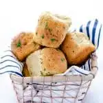 Soft, yeasty gluten free rolls made with garlic and herbs! These rolls are easy to make and have an amazing texture you wouldn’t believe until you try it! These gluten free dinner rolls truly are a revolutionary gluten free bread product. Serve them with holiday meals, Sunday dinner, or even with weeknight dinners. Gluten free bread recipe from @whattheforkblog - visit whattheforkfoodblog.com for more #glutenfree #glutenfreebread #glutenfreebaking #bread #yeastrolls #glutenfreerecipes #rolls