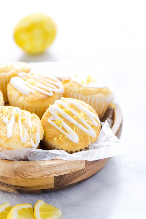 Gluten Free Lemon Ricotta Muffins in a wooden bowl lined with wax paper