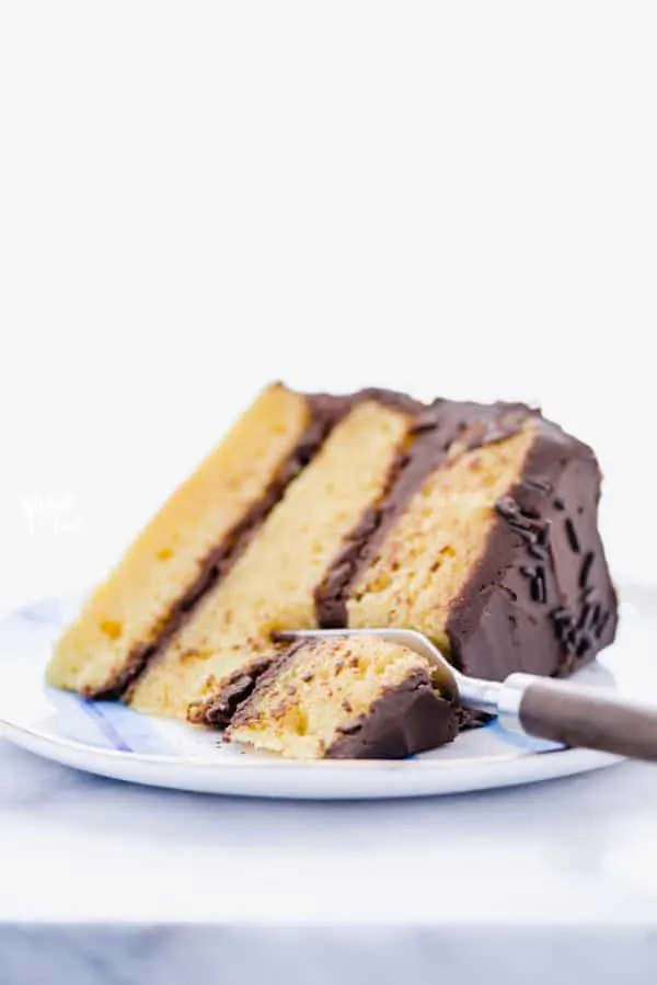 This gluten free yellow cake recipe from scratch is unlike any homemade yellow cake you’ve had! Homemade yellow cake is notorious for being dry - not this one! It’s moist and it’s hands down, the best yellow cake recipe I’ve ever made. An easy yellow cake recipe is one you need in your arsenal for the ultimate birthday cake or for any celebration. Gluten Free cake recipe from @whattheforkfoodblog - visit whattheforkfoodblog.com for more! #glutenfree #glutenfreecake #yellowcake #glutenfreerecipe