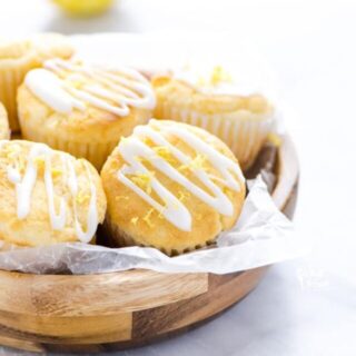 Gluten Free Lemon Ricotta Muffins in a wooden bowl lined with wax paper