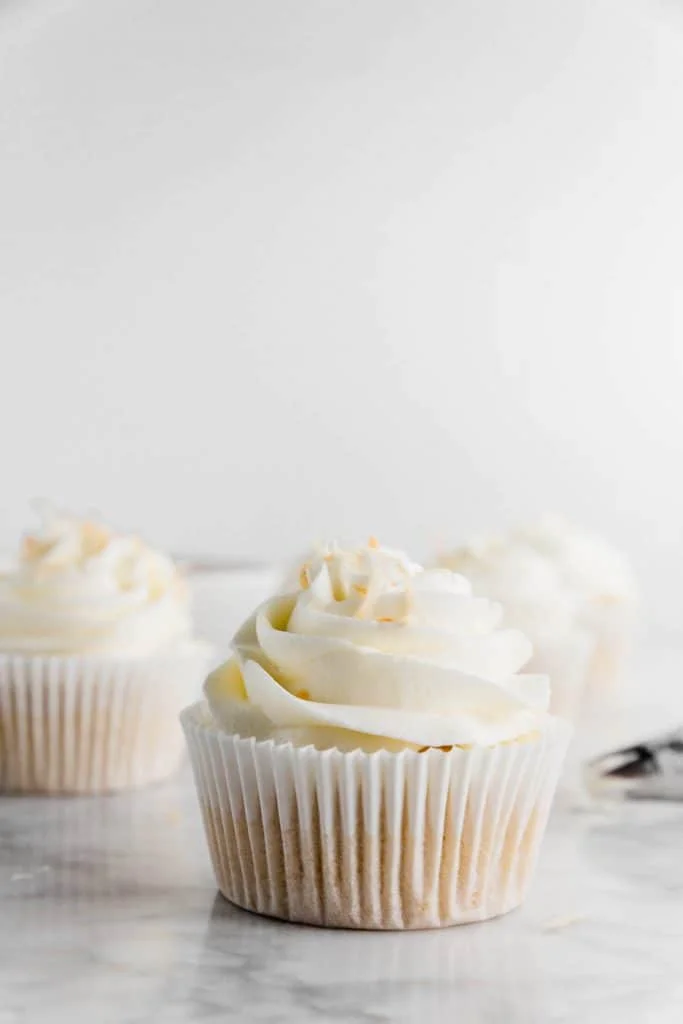 This simple Coconut Frosting recipe tastes anything but basic. It's got tons of tropical coconut flavor! It pairs great with coconut cake and chocolate desserts like brownies or cupcakes. Top it with some toasted coconut for an easy garnish. Recipe from @whattheforkblog - visit whattheforkfoodblog.com for more easy dessert recipes! #buttercream #frosting #dessert #coconut