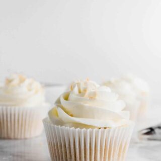 This simple Coconut Frosting recipe tastes anything but basic. It's got tons of tropical coconut flavor! It pairs great with coconut cake and chocolate desserts like brownies or cupcakes. Top it with some toasted coconut for an easy garnish. Recipe from @whattheforkblog - visit whattheforkfoodblog.com for more easy dessert recipes! #buttercream #frosting #dessert #coconut