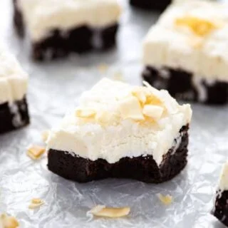 Rich and fudgy gluten free brownies are topped with creamy coconut frosting for the ultimate decadent dessert! These brownies are so full of chocolate and coconut flavor and they just melt in your mouth. Bring them to your next party or potluck! Top them with toasted coconut or toasted coconut chips for the best coconut dessert to make for a crowd. Gluten free brownie recipe from @whattheforkblog - visit whattheforkfoodblog.com for more gluten free dessert recipes! #glutenfree #brownies #coconut