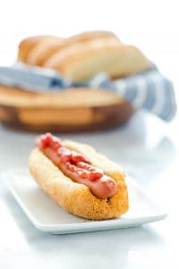 These Homemade Gluten Free Hot Dog Buns are soft and don’t fall apart like store-bought buns. They’re easy to make and worth the effort. They’re great for sausages, brats, tuna boats, or whatever else you want to fill your roll with! Bonus, they even stand up on their own so your hot dogs stays put. Gluten Free Bread recipe from @whattheforkblog - visit whattheforkfoodblog.com for more #glutenfree #glutenfreerolls #glutenfreebread #glutenfreebaking