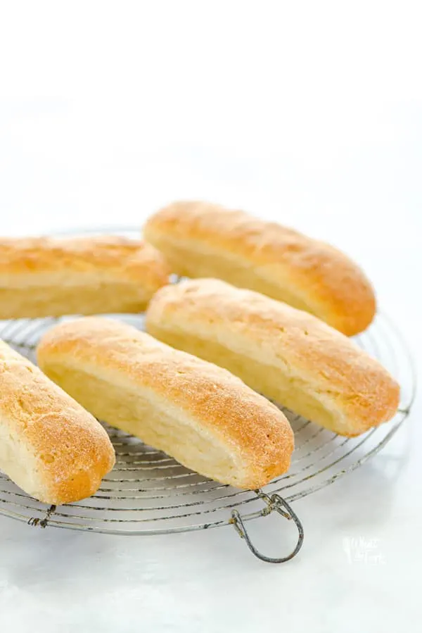 gluten free hot dog buns on a round wire rack