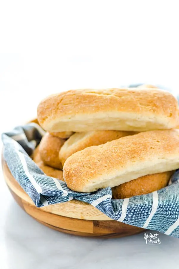 Gluten Free Hot Dog Buns in a wood bowl lined with blue linen