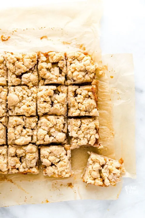 These easy Gluten Free Apple Pie Bars taste just like apple pie but are less work to make! They have a shortbread-like crust, homemade apple pie filling, and crumb topping. The topping is from the same dough as the crust so they’re simple to make! For an even easier version, use a can of apple pie filling! This is a great fall dessert recipe that’s perfect for harvest parties, Halloween parties, and potlucks. Visit whattheforkfoodblog.com for more! #glutenfree #applpie #applerecipes #desserts