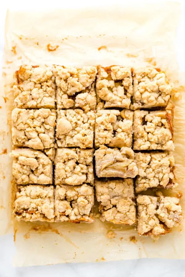 These easy Gluten Free Apple Pie Bars taste just like apple pie but are less work to make! They have a shortbread-like crust, homemade apple pie filling, and crumb topping. The topping is from the same dough as the crust so they’re simple to make! For an even easier version, use a can of apple pie filling! This is a great fall dessert recipe that’s perfect for harvest parties, Halloween parties, and potlucks. Visit whattheforkfoodblog.com for more! #glutenfree #applpie #applerecipes #desserts