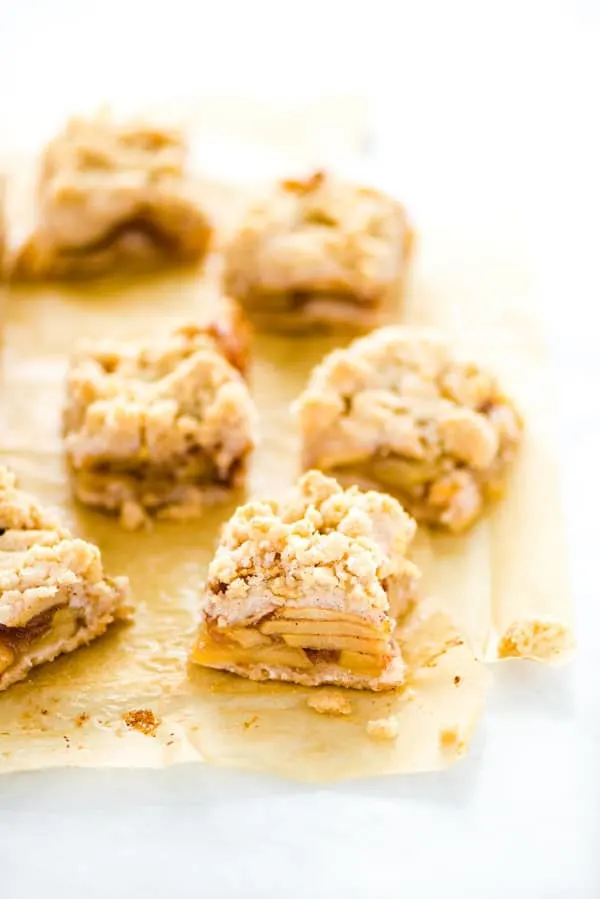 Gluten Free Apple Pie Bars arranged on unbleached parchment paper