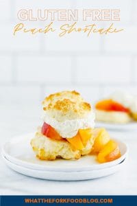Easy gluten free peach shortcake is made with gluten free drop biscuits that are topped with fresh sweetened peaches and homemade whipped cream. It's the perfect summer dessert to share during peach season. This recipe is best with fresh peaches! Easy gluten free dessert recipe from @whattheforkblog - visit whattheforkfoodblog.com for more gluten free dessert recipes! #glutenfree #peach #peachshortcake #dessert #glutenfreedessert #easyrecipe #shortcake