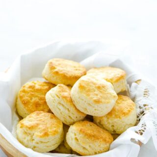 Gluten Free Buttermilk Biscuits in a wood bowl lined with a white towel