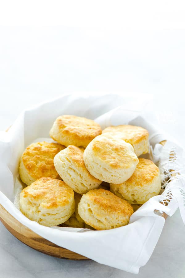Gluten Free Buttermilk Biscuits in a wood bowl lined with a white towel