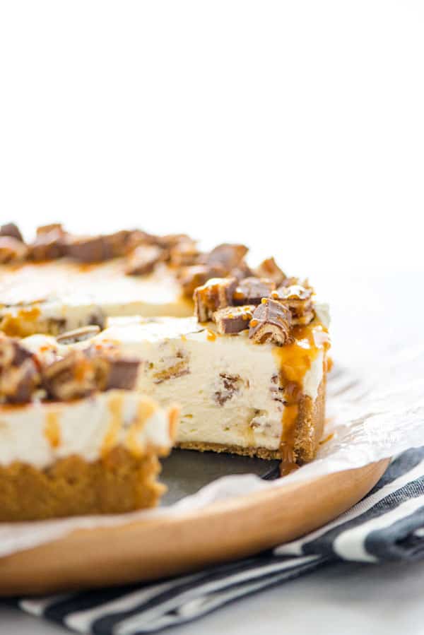 AD: This quick and easy Chocolix No Bake Cheesecake recipe features a smooth and creamy no bake cheesecake base on top of a classic graham cracker crust. The cheesecake filling is mixed with chopped Schar Chocolix and refrigerated until set. Before serving, top it with a drizzle of caramel and even more chopped Chocolix. This dessert is perfect any time of the year and is a simple and safe option to serve for anyone who has Celiac Disease or is gluten intolerant. #glutenfree #cheesecake #nobake
