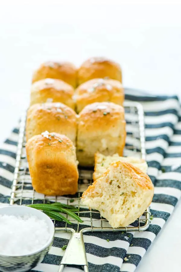 Gluten Free Rosemary Rolls are easy to make and are a great gluten free bread to add to your dinner rotation! They're based on my popular gluten free dinner roll recipe but they're flavored with fresh rosemary. These 1 hour dinner rolls pair great with Sunday dinners, weeknight meals, and any holiday meal! Gluten Free Rolls don't have to be intimidating - just follow this tried and true recipe! From @whattheforkblog visit whattheforkfoodblog.com for more gluten free baking recipes! #glutenfree