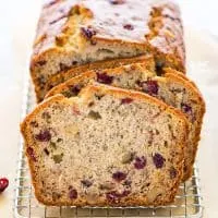 This popular gluten free banana bread recipe got a seasonal update and turned into a spectacular loaf of Cranberry Banana Bread. There’s a dairy-free option too! This simple quick bread is easy to make and is perfect for breakfast, brunch, snacking, lunch boxes. It’s also a great side dish for Thanksgiving or Christmas dinner. Gluten free bread recipe from @whattheforkblog - visit whattheforkfoodblog.com for more gluten free baking recipes. #glutenfree #bananabread #quickbread #glutenfreebread