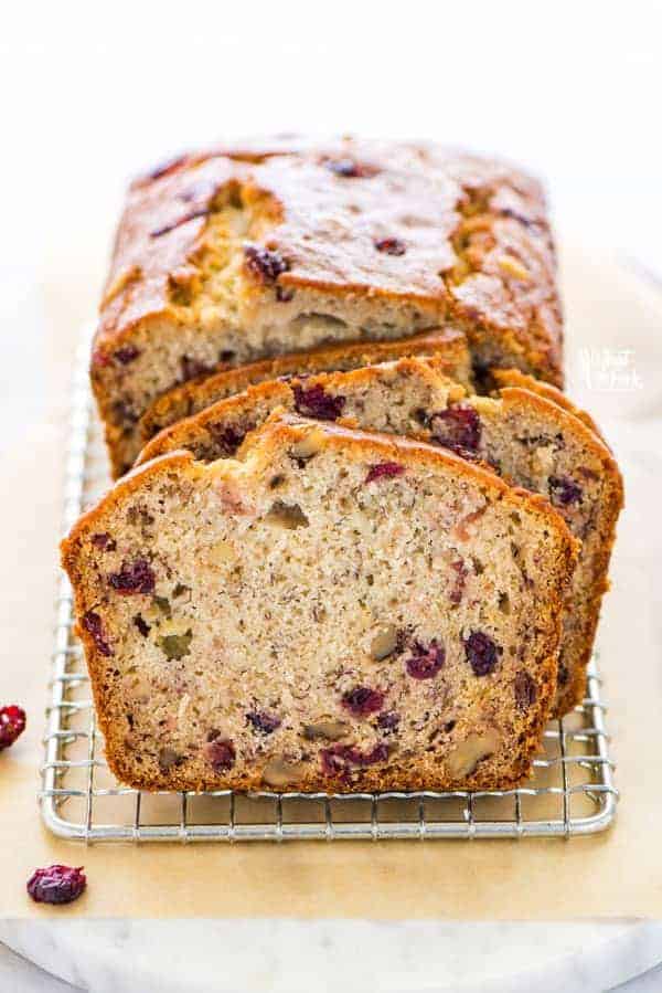 This popular gluten free banana bread recipe got a seasonal update and turned into a spectacular loaf of Cranberry Banana Bread. Theres a dairy-free option too! This simple quick bread is easy to make and is perfect for breakfast, brunch, snacking, lunch boxes. Its also a great side dish for Thanksgiving or Christmas dinner. Gluten free bread recipe from @whattheforkblog - visit whattheforkfoodblog.com for more gluten free baking recipes. #glutenfree #bananabread #quickbread #glutenfreebread