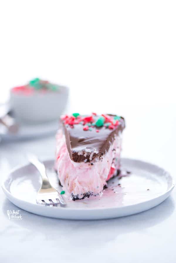 This Peppermint Ice Cream Pie is a family Christmas tradition! It’s our must-make Christmas dessert. This simple ice cream no-bake dessert recipe is so easy to make and it has to be made ahead of time so it’s perfect for holiday parties. Make it gluten free with with a gluten free chocolate cookie crust or use regular Oreos if you don’t need gluten free. Recipe from @whattheforkblog - visit whattheforkfoodblog.com for more! #Christmas #PeppermintStick #icecream #dessert #nobake #nobakerecipe