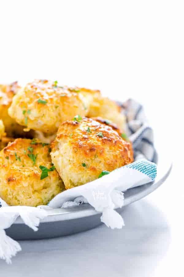 Gluten Free Cheddar Bay Biscuits in a towel lined silver serving bowl