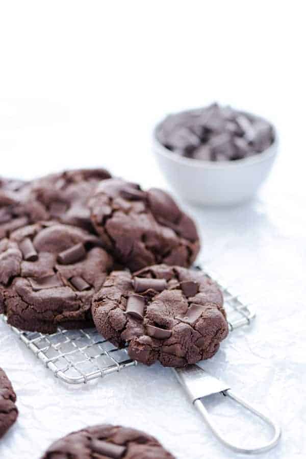 Gluten Free Double Chocolate Chip Cookies piled on a small wire metal rack